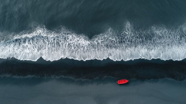Aerial drone view of a serene coastal landscape with a vibrant red boat on a black sand beach under a clear blue sky - Powered by Adobe