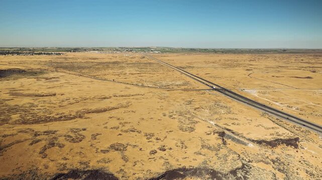 Aerial drone view of desert highway through dry plains, Idaho USA