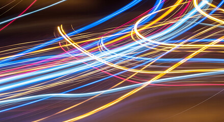 Abstract light streaks create a vibrant, dynamic motion blur pattern
