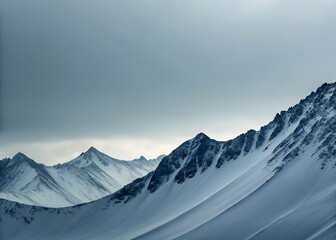 Snow Covered Mountain Range Under a Grey Sky