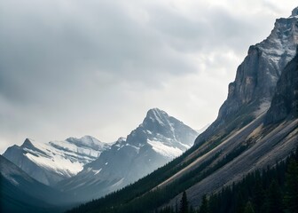 Snow Capped Mountain Peaks Under a Cloudy Sky