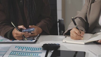 Financial analysts analyze business financial reports on a digital tablet planning investment project during a discussion at a meeting of corporate showing the results of their successful teamwork. - Powered by Adobe