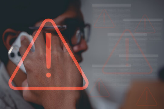 young man using smart mobile phone calling or answer the phone with virtual triangle caution icon in concept of risk and network security online