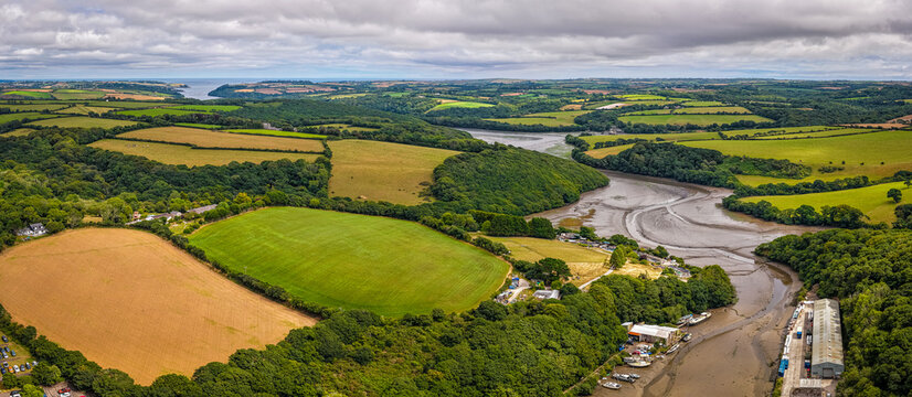 Aerial view of Gweek village with surrounding green fields and countryside