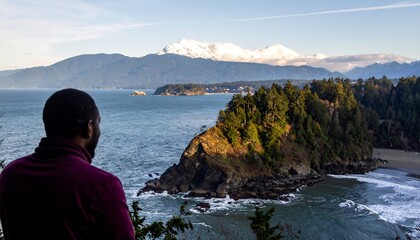A tranquil coastal vista showcasing a rugged coastline, a serene beach, and majestic mountains rising above the horizon.