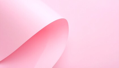 A soft, curved sheet of pale pink paper creates a delicate, abstract design against a solid backdrop of a similar hue.