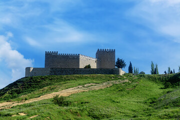 Stone fortress of Castillo de Monzon de Campos in Palencia under deep blue sky