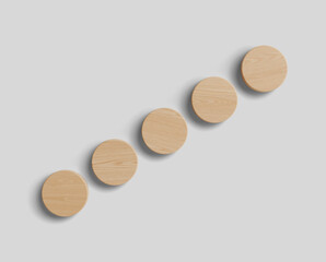 Wooden round wall hooks arranged diagonally on a light grey background creating a modern minimalist interior design concept mock up scene. 3D Rendering