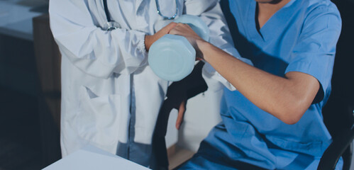 Person using hand weight with support of nurse