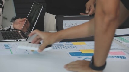 Financial analysts analyze business financial reports on a digital tablet planning investment project during a discussion at a meeting of corporate showing the results of their successful teamwork. - Powered by Adobe