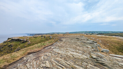 Panoramic view of the cliffs and ocean under a cloudy sky offers a stunning coastal scenery.
