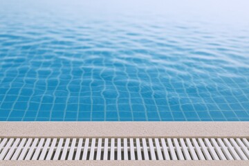 Swimming Pool Edge with Blue Water and Tile Background, Vacation and Relaxation Concept