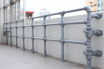 Industrial balcony safety railing with exposed iron pipes and bolted connections, sturdy and functional style