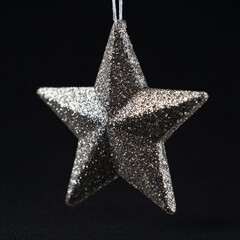 Golden silver golden Christmas tree star on a black background.