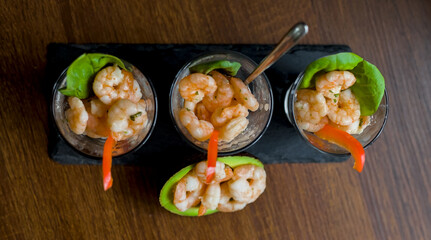Top View of Shrimp Prawn Cocktail with Avocado, Pepper and Spinach on a Slate, Healthy Seafood Appetizer