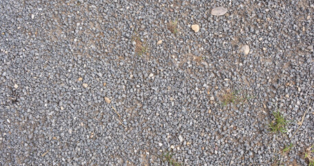 Rough gray gravel as textured background surface, natural stone texture for construction or landscape themes