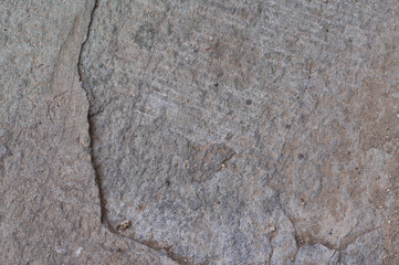Detailed Texture Close-up of Rough Natural Stone Surface with Grains and Cracks