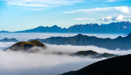 A majestic mountain range rises above a sea of clouds, showcasing a serene and picturesque landscape.