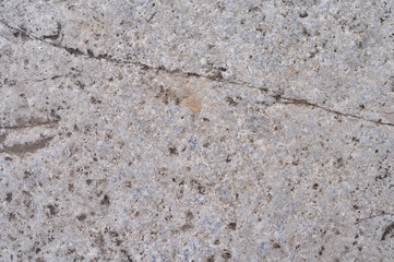 Close up textured natural granite rock surface with a fine grain and subtle lines