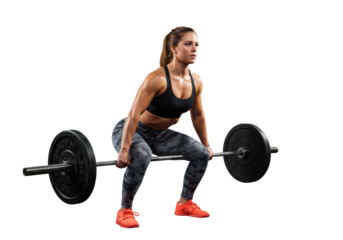 Young caucasian woman with muscular definition in black sports bra, grey leggings, orange shoes, gripping heavy barbell on white studio background, deadlift squat, intense focus, concept of strength