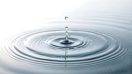 Captivating Ripple Effect A Close-Up of Water Droplets Creating Serene Concentric Circles and Reflections on a White Background
