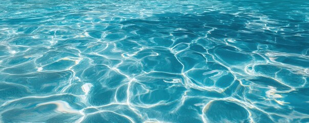 Obraz premium Clear and vibrant blue water fills the pool, shimmering under the midday sunlight and offering a refreshing sight for anyone nearby. The gentle ripples enhance the tranquil vibe