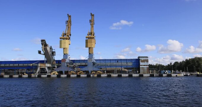 Gdansk Poland water front industrial cargo port cranes. Baltic coast of northern Poland. World War II started here with German invasion. Economic international port. Historical buildings, tourism.