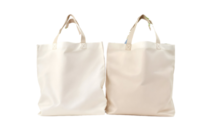 Two blank beige canvas tote bags isolated on a white background. Eco-friendly reusable shopping bag mockup for branding, design, or promotional purposes