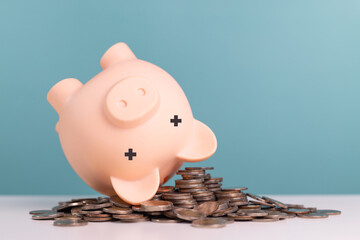Crisis, recession, finance, loss concept. Piggy bank upside down on coins stack represents the...
