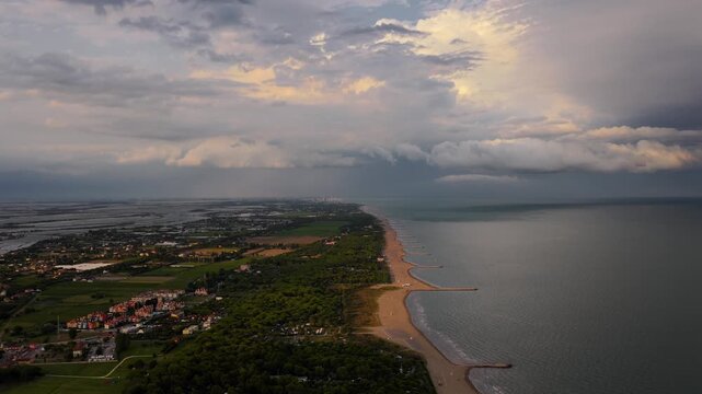 aerial view of Sunset storm clouds approaching Cavallino Treporti coast, Italy