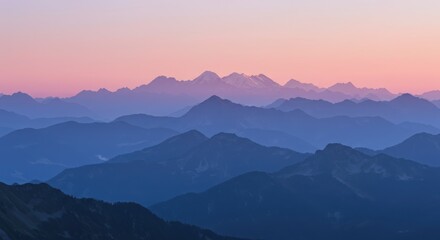 Obraz premium Layered mountain range at sunset with a soft pink and blue gradient sky