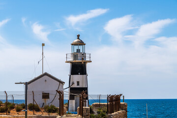 The old black and white lighthouse in the walled city of Old Acre, Akko Israel.

