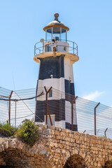 The old black and white lighthouse in the walled city of Old Acre, Akko Israel.
