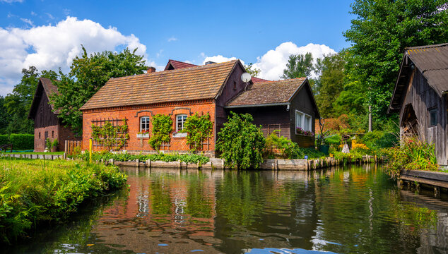 Tourismus in Brandenburg, Landschaft mit Flie&szlig;gew&auml;ssern, H&auml;usern, K&auml;hnen, Kajaks und Waldgebiet im Spreewald in L&uuml;bbenau und Lehde, Brandenburg, Deutschland