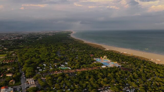 Aerial view of Cavallino Treporti water park and beach at golden ho
