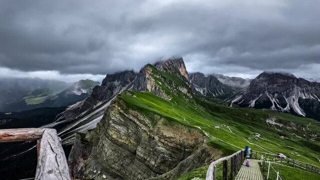 Timelapse of hikers on Seceda ridge under fast moving storm clouds