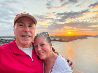 Couple Enjoying Sunrise View Over Coastal Landscape by the Water in England
