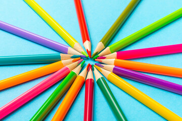 Fototapeta premium Colored pencils on a bright colored background. Equipment for coloring. Stationery for creativity.Back to school. Flatlay. Children's Creativity and Education. Rainbow.Space for text. Copy space.