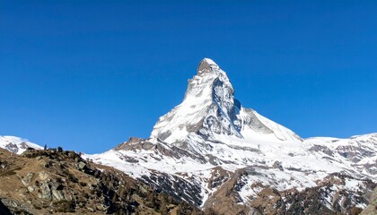 Iconic Matterhorn mountain peak in Switzerland with snowy summit. Perfect for travel posters, tourism branding, and adventure ads.