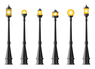 A diverse collection of black street lamps stands in a neat row, each topped with a unique light bulb shape emitting a warm, inviting glow on a plain backdrop. © Creativeclipcloud