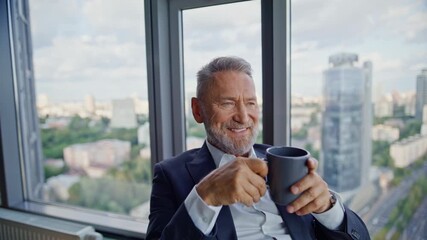 Wealthy executive holding coffee cup sitting by office panoramic window closeup. - Powered by Adobe