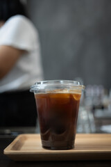Ice Americano coffee with ice cubes in takeaway glass