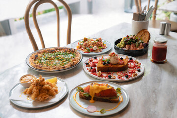 Assorted gourmet dishes on a marble table at modern restaurant