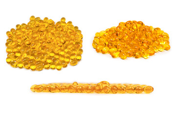 A group of yellow capsules isolated on a white background.