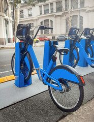 City bike rack with blue bikes.