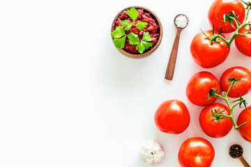 Tomato frame with suase and garlic on white background top-down copy space