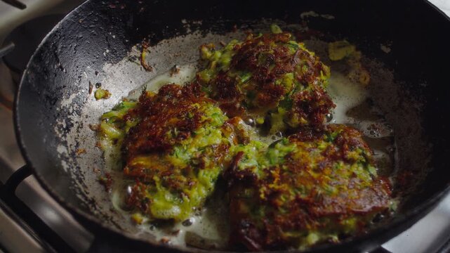 Close-up, vegetarian vegetable pancakes fried in a pan in boiling oil