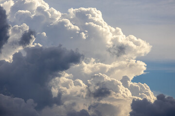 Dramatic afternoon sky with stunning cloud formations. This captivating image features beautiful white and gray clouds floating majestically, creating a serene yet powerful aerial view.