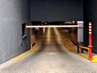 lighted underground parking lot in a residential building or shopping center, signs and barrier
