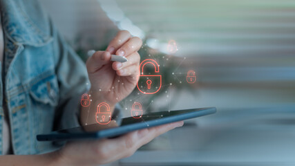 Hand using a digital pen with tablet and unlocked padlock icons, representing cybersecurity data...